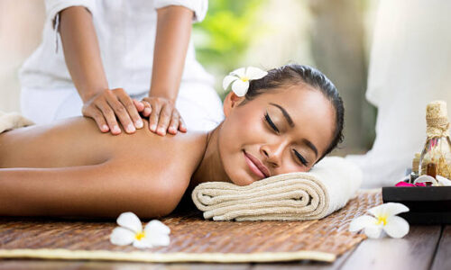 Spa massage outdoor, Balinese woman receiving back massage
